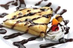 Strawberry Crepe drizzled with Chocolate.